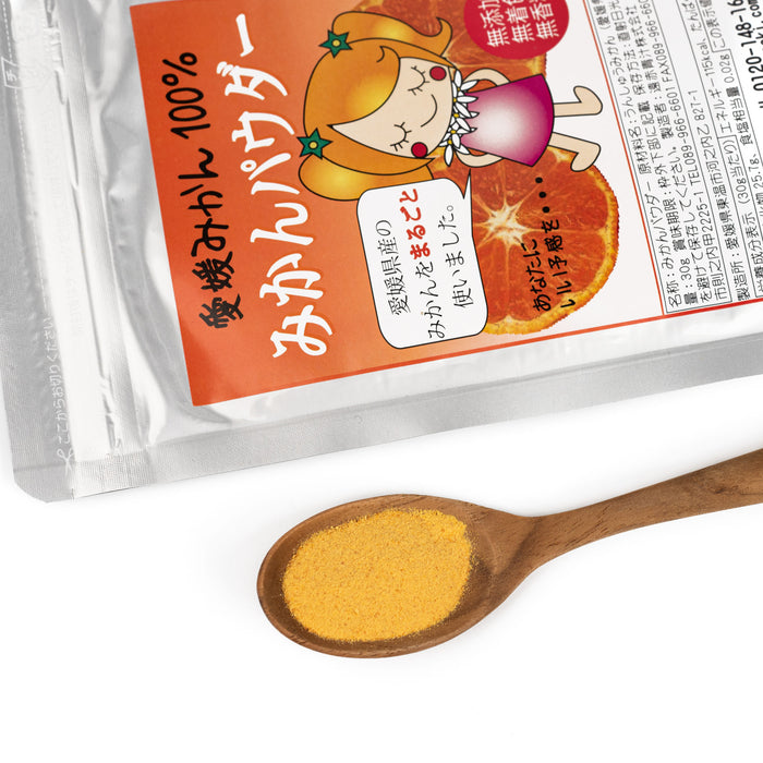 A spoon of mikan powder next to a package of the product