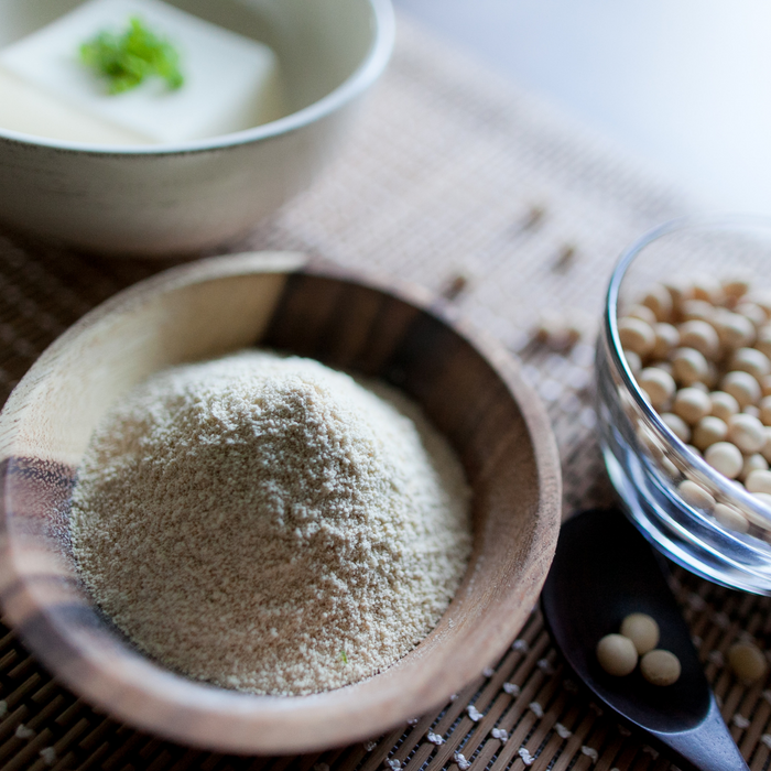 Okara powder next to tofu and soy beans