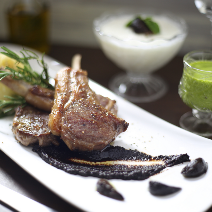 A plate of lamb chop with black garlic sauce
