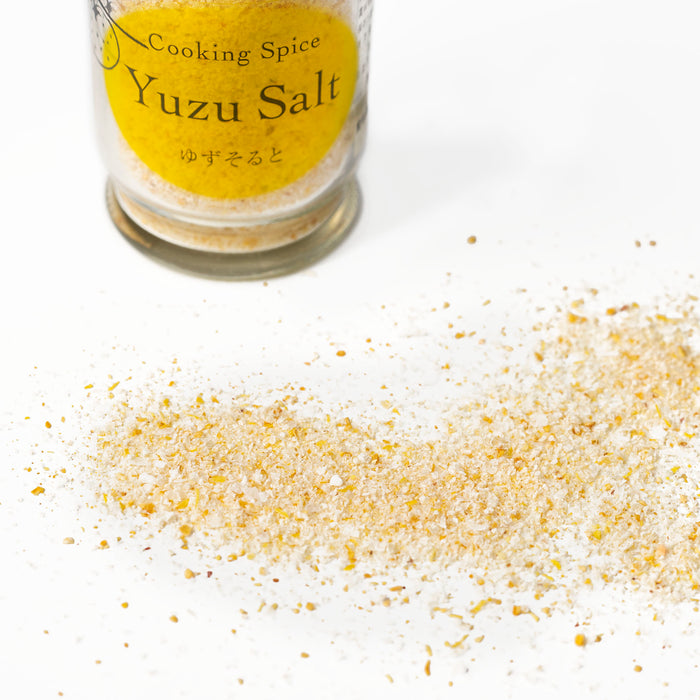 Scattered yuzu salt next to bottle of the product