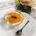 A glasses of kuzu dessert topped with orange sauce
