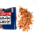 Overhead angle of scattered dried bonito flakes popping out of package of the product