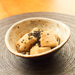 A bowl of sesame tofu topped with black sesame seeds