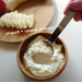 Man adding a spoon of okara powder onto yogurt
