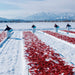 Women throwing chili peppers on to snow ground