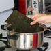 Man putting ma-kombu into boiled water