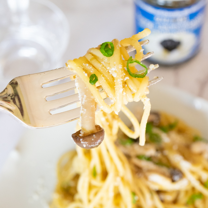 Man taking mushroom pasta with fork
