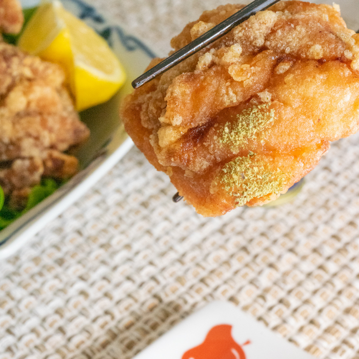 Man taking a fried chicken with chopsticks