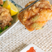 Man taking a fried chicken with chopsticks