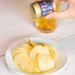 Man sprinkling sansho pepper onto potato chips